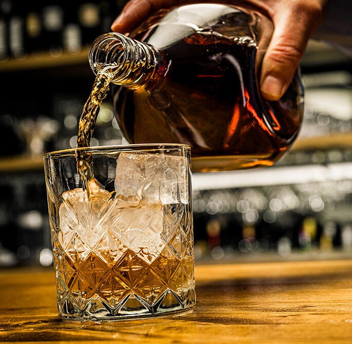 a bottle and a glass of whisky