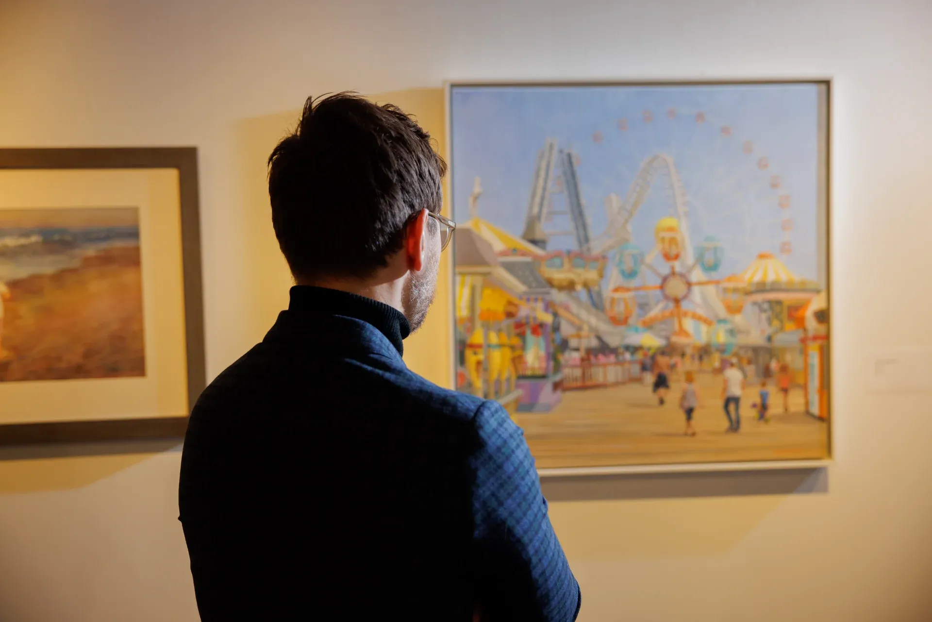 a man looking at a painting