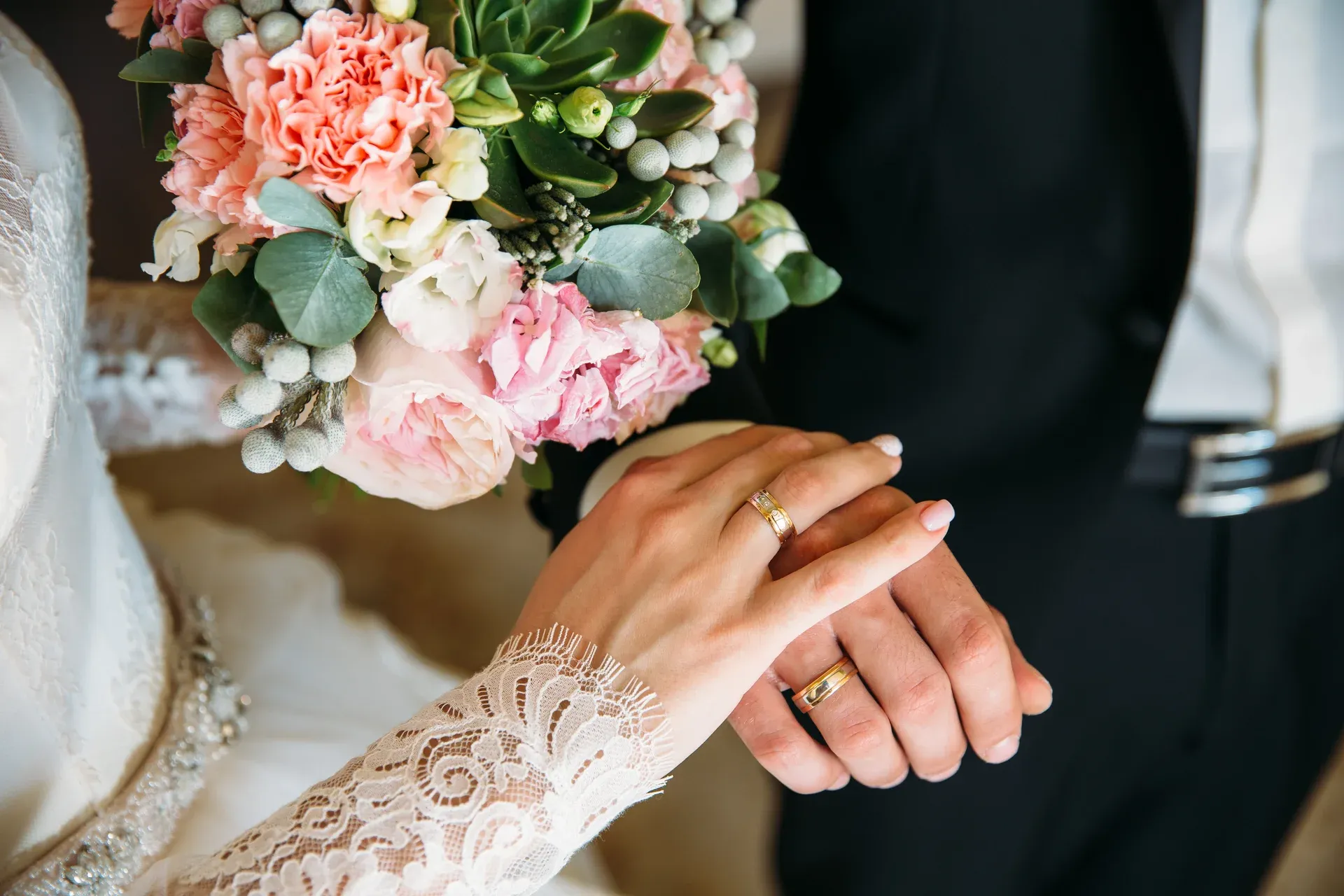 Close up of wedding rings and flowers