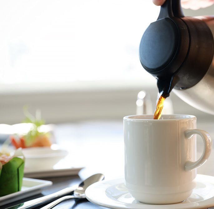 coffee being poured into a mug
