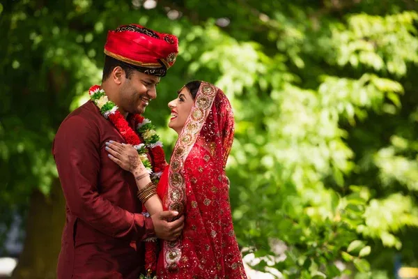 loving indian couple embracing outdoors in ceremonial garb