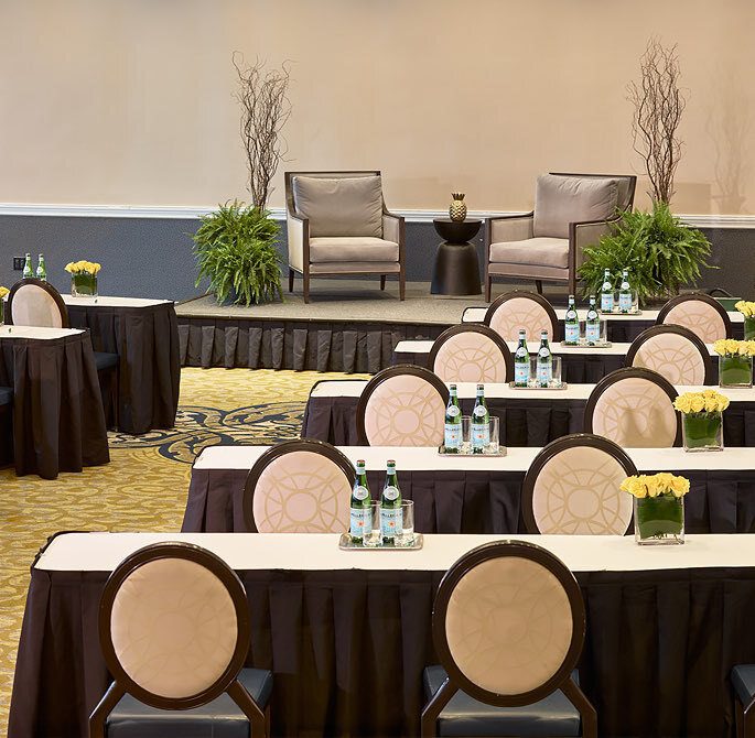 salon meeting area with podium that has 2 chairs